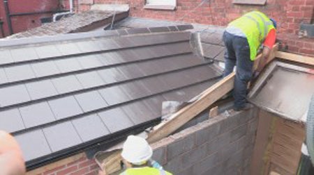 Brand new slates sit atop the new extension roof, already doing their job during a short rainy spell.