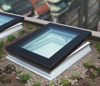A pitched roof window used with a kerb as a flat roof window