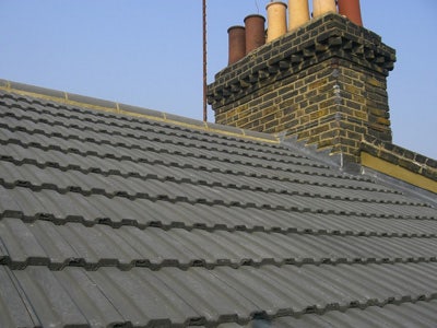 Grey ridge tiles on a concrete profile tile roof