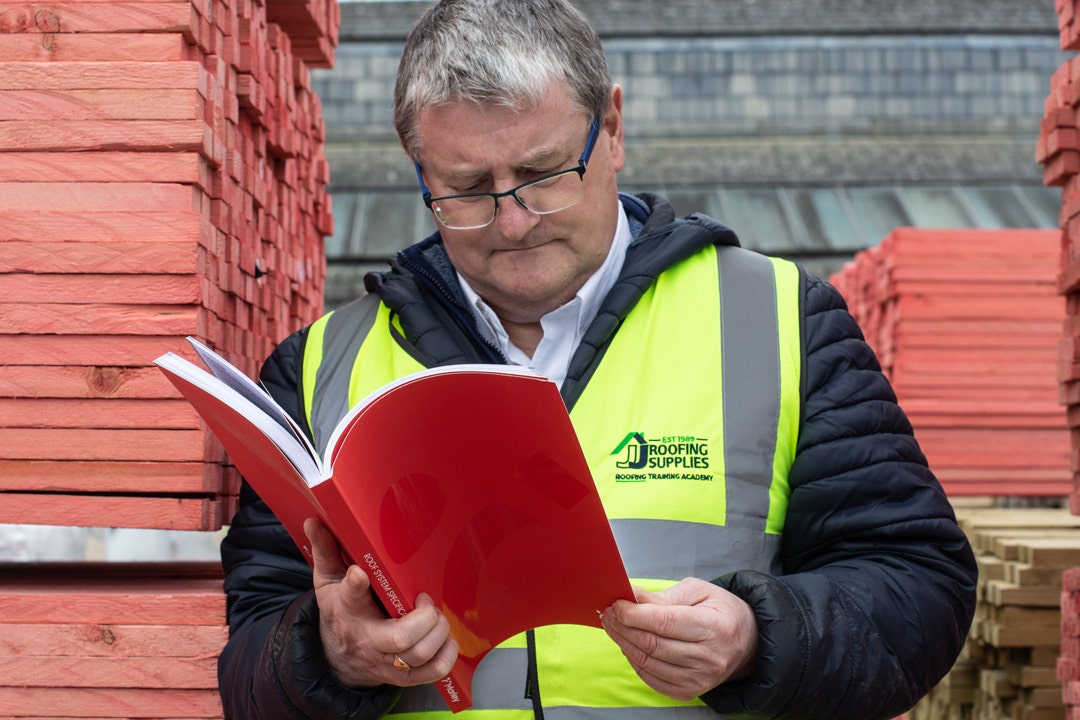 Steve front on holding his favourite roofing literature, the Marley Roof System Specification Guide