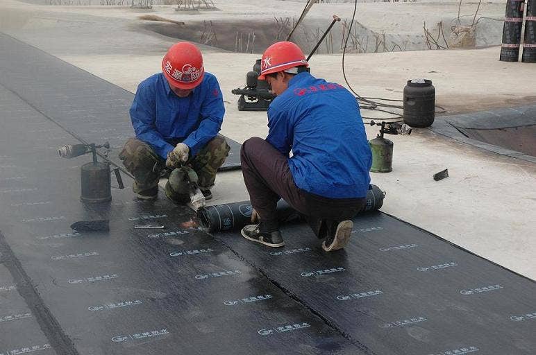 modern roofing felt being installed on a large flat roof