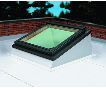 pitched roof window installed on a flat roof with an angled upstand