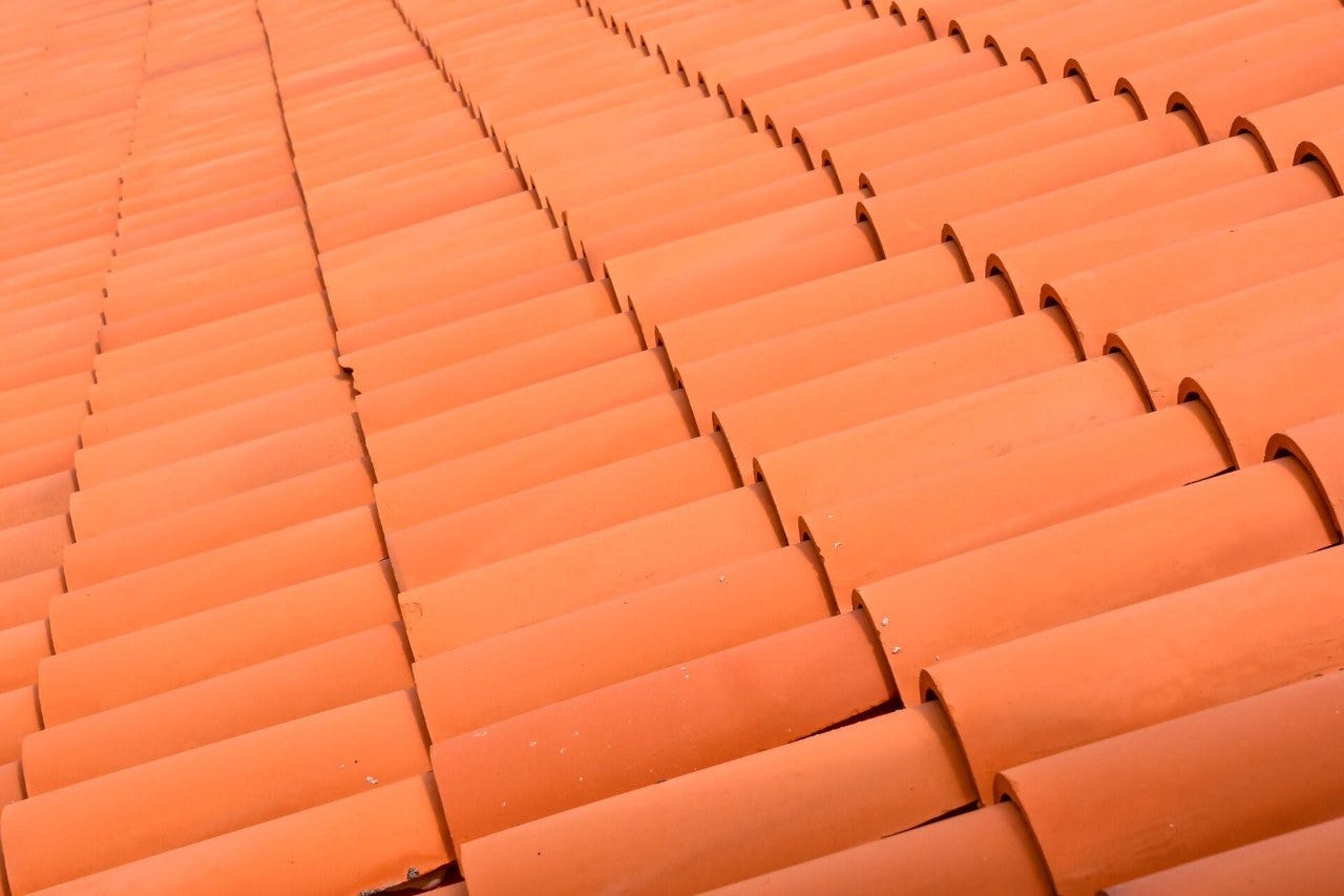 close up shot of a home's roofing with clay roof tiles installed