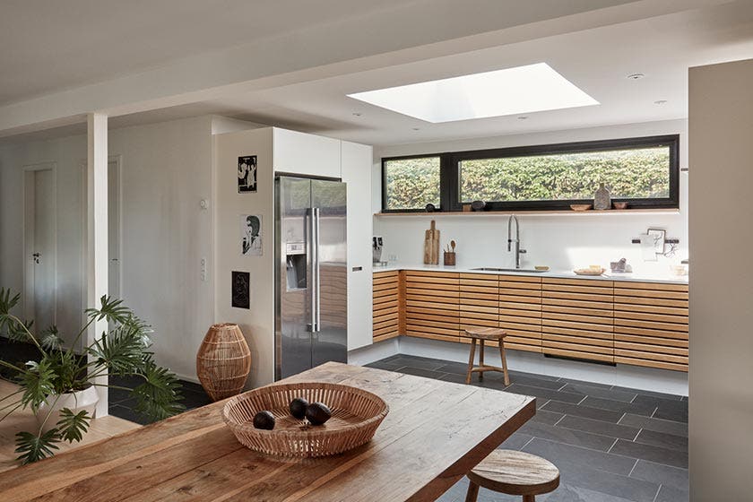 Modern kitchen with large flat roof window in the centre