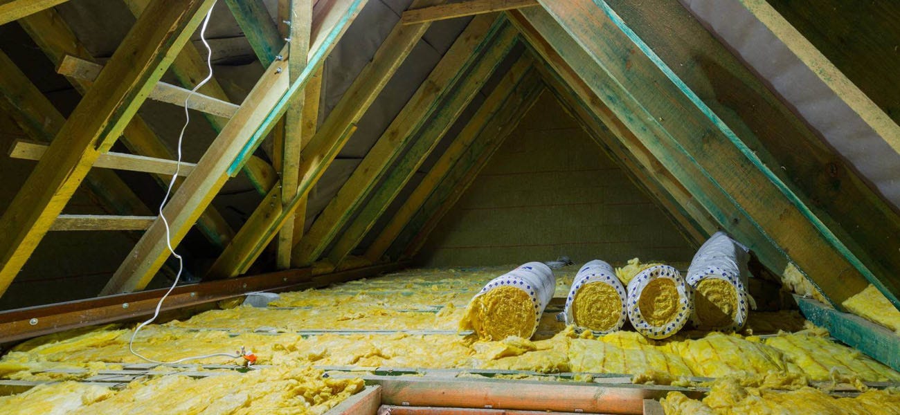 Rolls of loft insulation in loft
