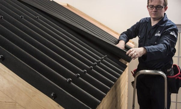 a man handling bitumen sheets