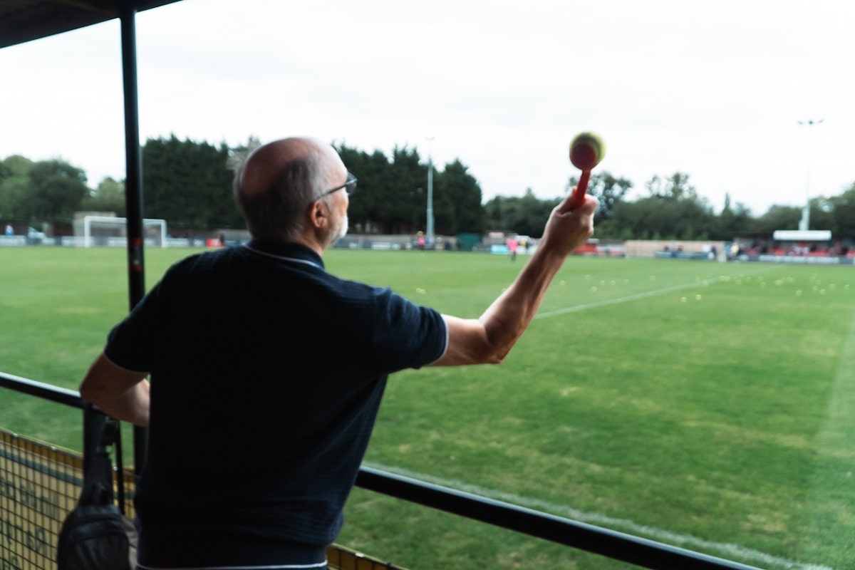A fan uses a dob ball thrower in the Hadley FC Half-Time Tennis Ball Throwing Competition at Brickfield Lane