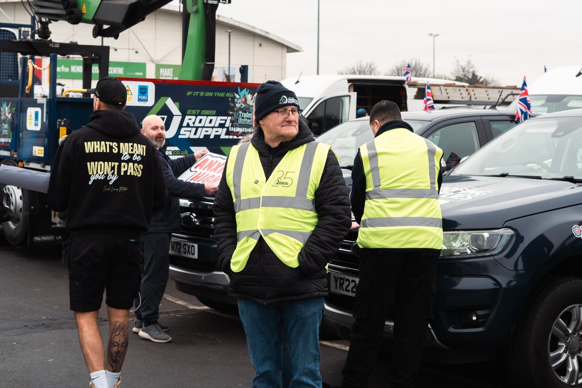 Steve Wells surveying the rally as JJRS staff apply sticker for theStop Tool Theft Rally
