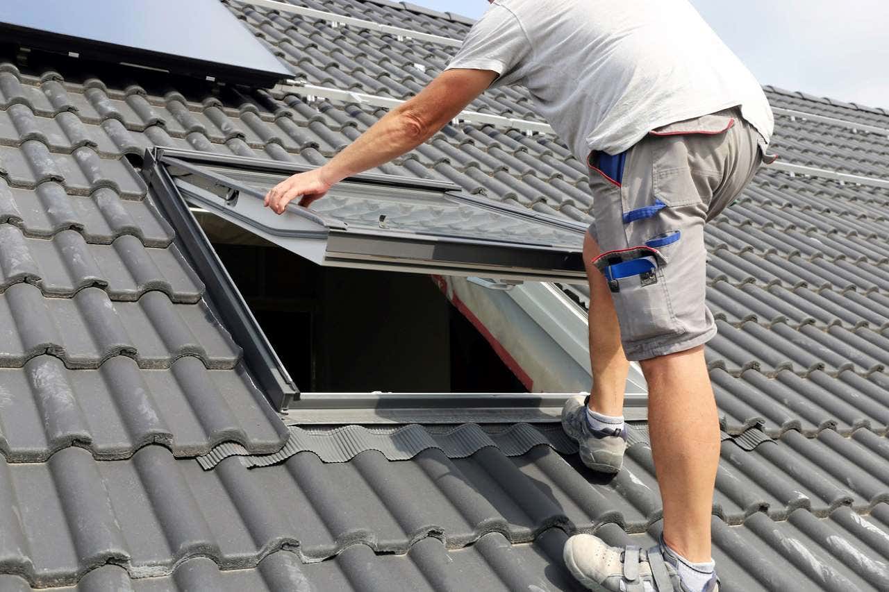 man installing a skylight
