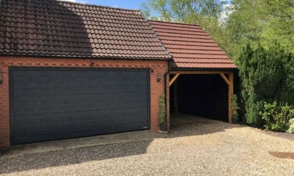 a garage with tile effect roof sheets installed